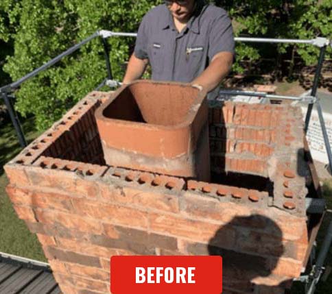 Stock photo of chimney crown before repair-C and C Chimney Chimney before crown repair - man laying brick with safety equipment before crown installation