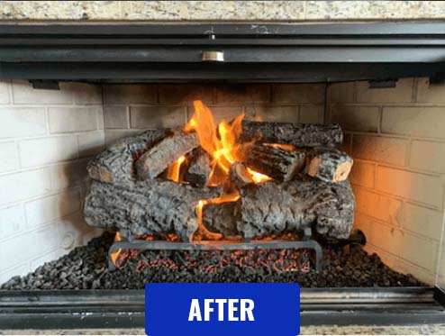 Stock photo after gas log cleaning - C and C Chimney Gas logs after cleaning and logs rearranged with a fire