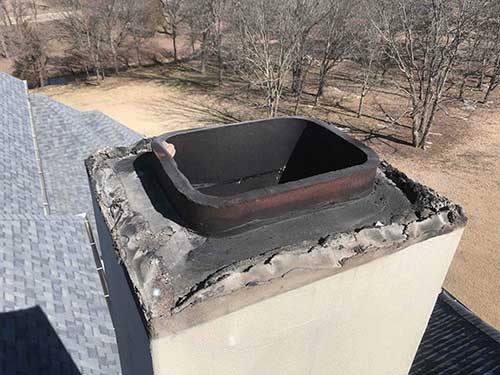 Stock photo of flue before relining - C and C Chimney Chimney before relining creosote all over the top of ceramic flue