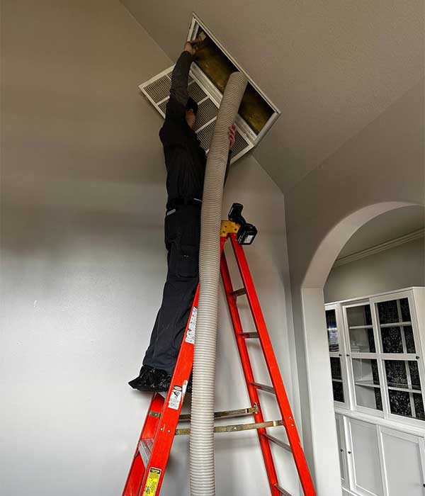 Technician Cleaning Air Duct Technician Cleaning Air Duct