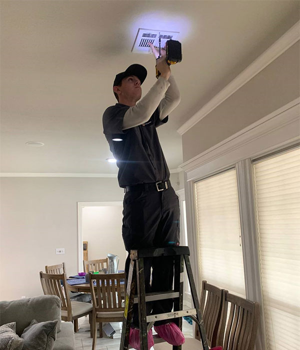 Technician Inspecting Air Ducts Technician Inspecting Air Ducts