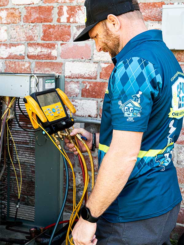 Technician working on HVAC Technician working on HVAC
