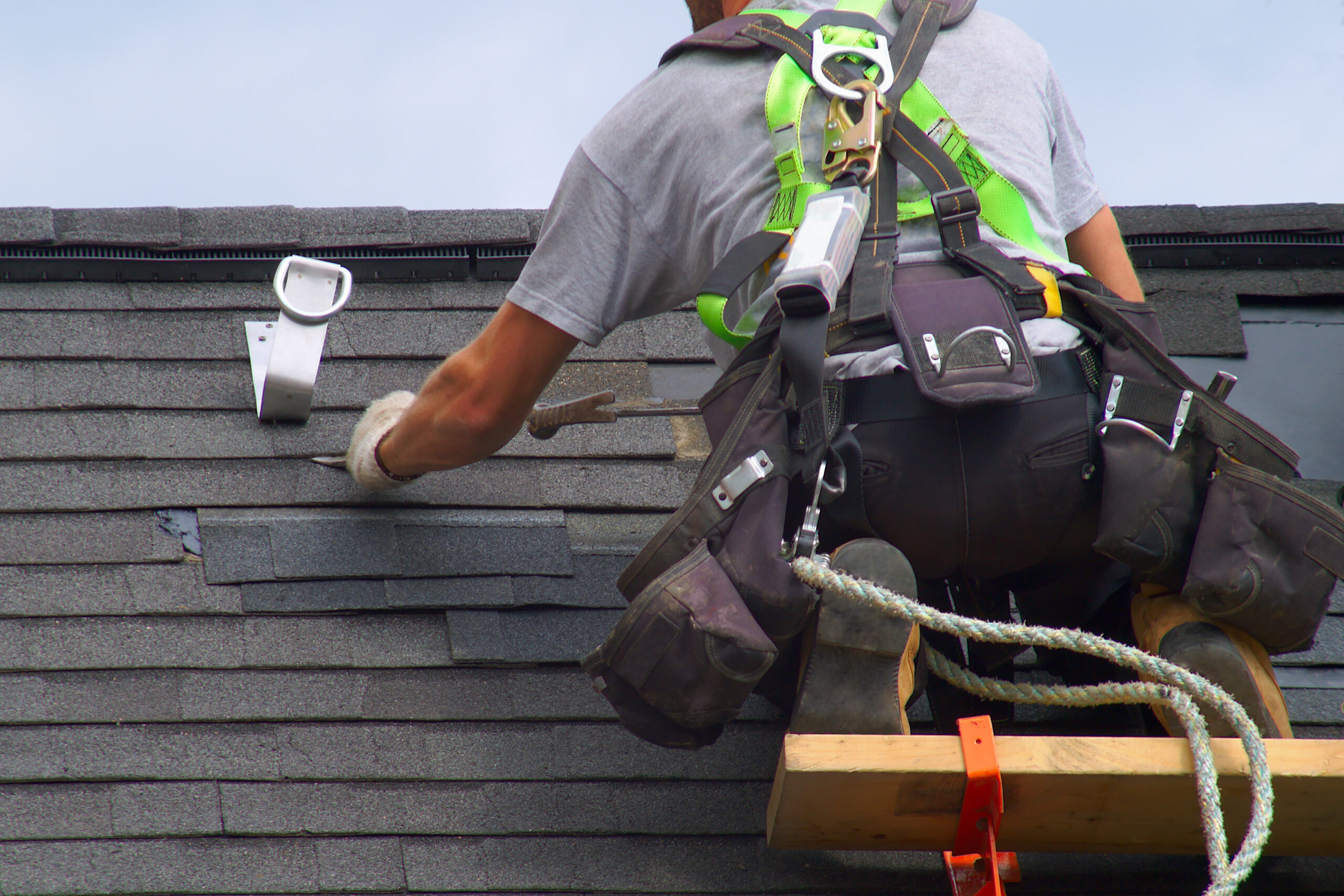 Stock image of a technician working on a roof.